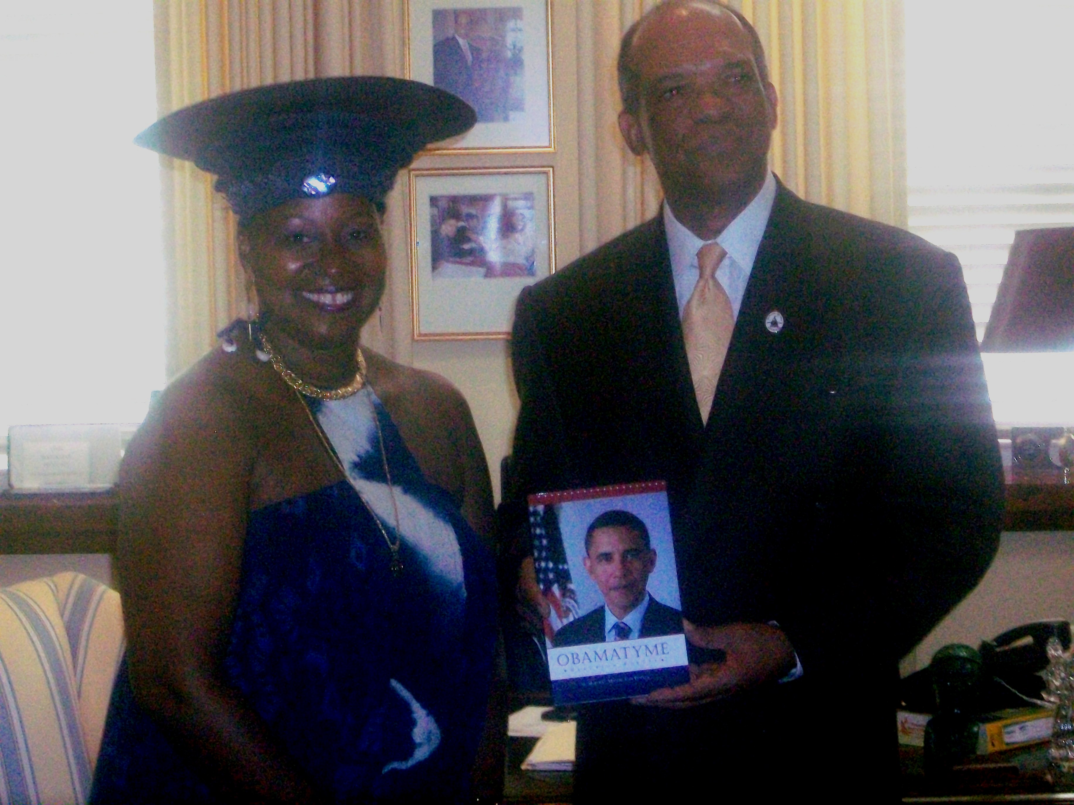 Premier_Dr._Ewart_Brown_receiving_Obamatyme_from_Poet_Melodye_Micere_Van_Putten.JPG